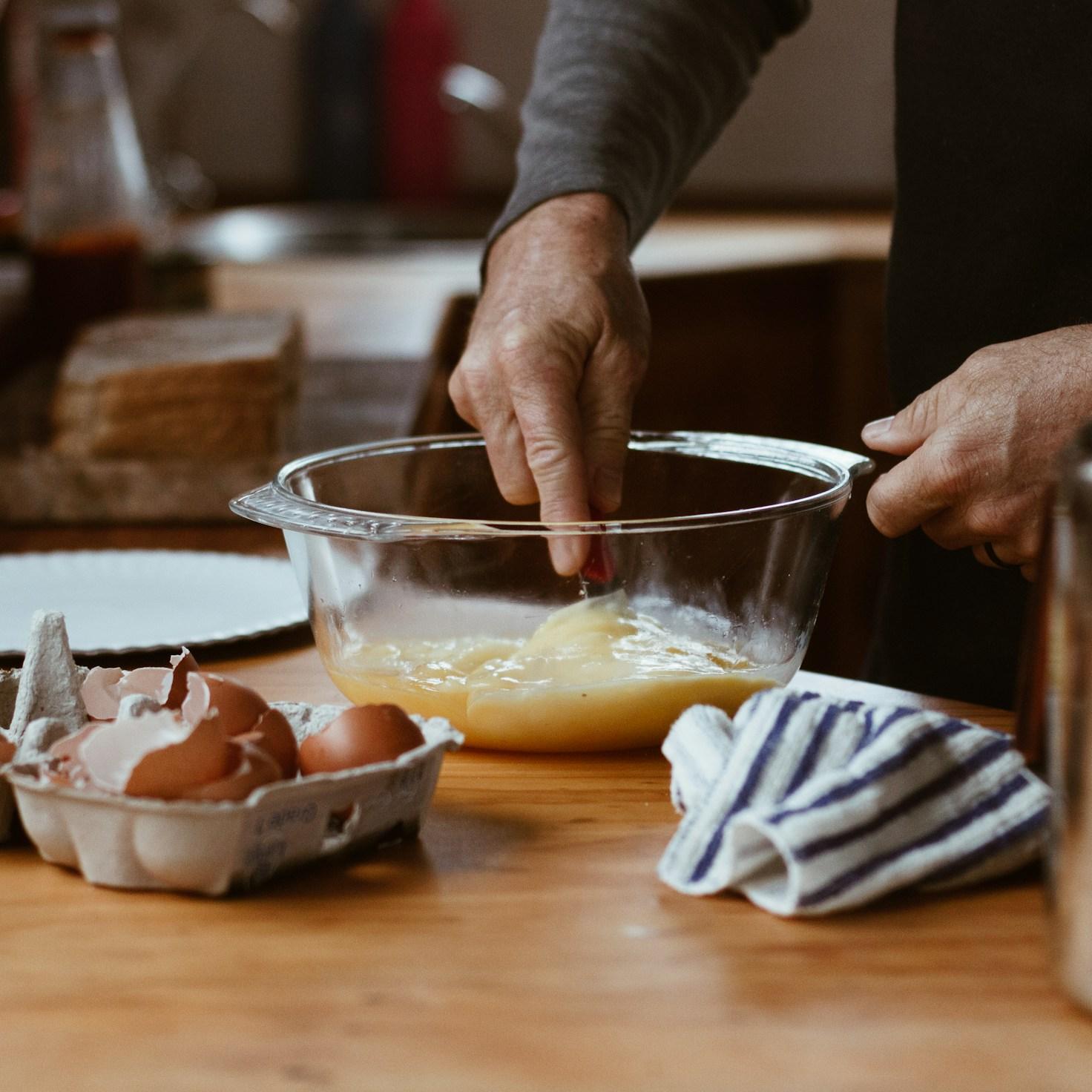 Community members teamwork in a contemporary kitchen, exchanging recipes and techniques